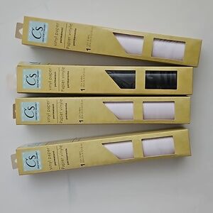 Four unopened packages of vinyl paper three white one black 12-in x 48 in